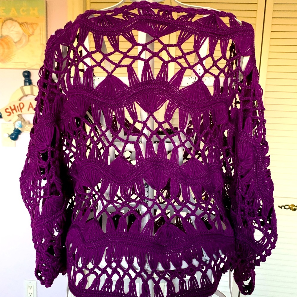 This beautiful purple crocheted sweater can be paired it was just about anything